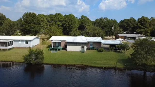 a view of a patio with table and chairs and a lots of flower plants