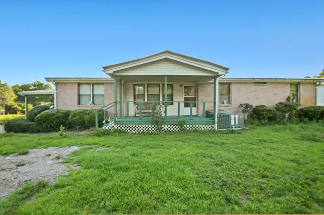 a view of a house with yard and a garden