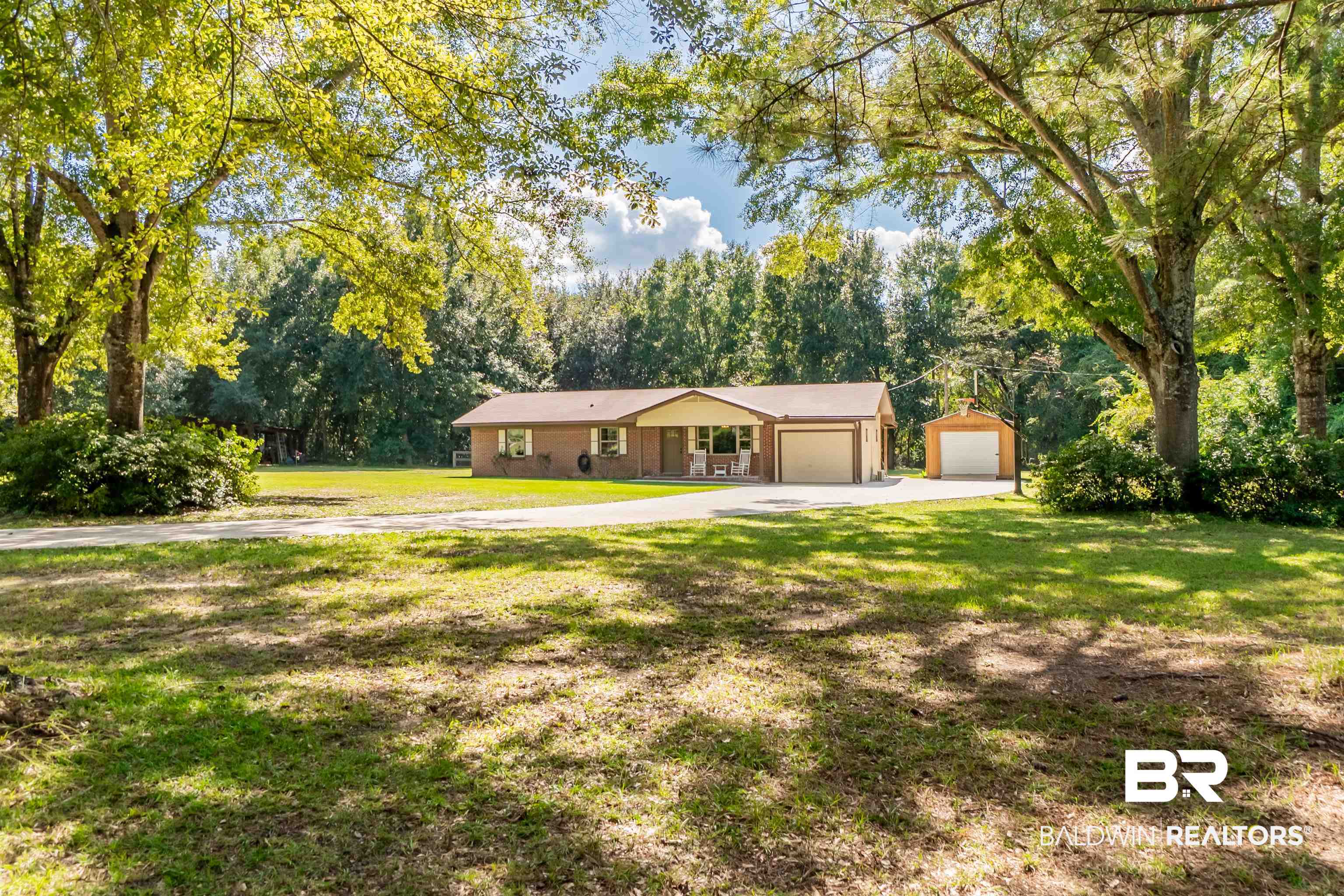 Home is Situated down a long concrete drive for a Private Setting and Surrounded by Mature Trees & landscaping.
