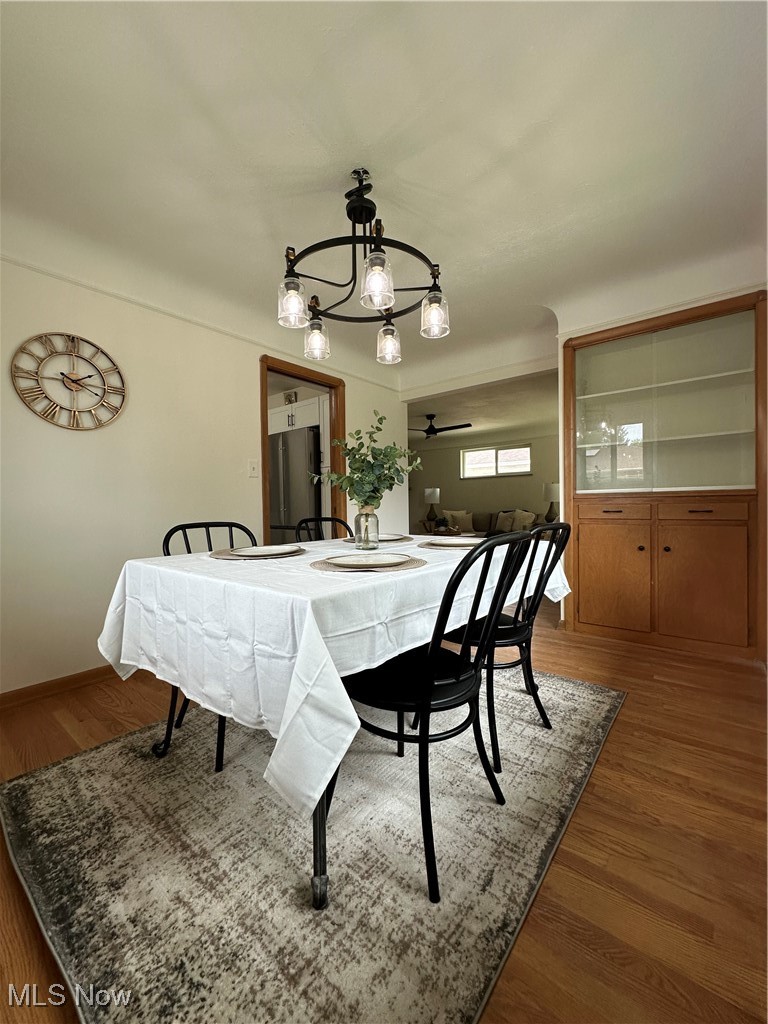 4281 Grannis Road Cleveland, OH 44126 - Photo 15 of 30 Dining area featuring wood finished floors, a chandelier, ceiling fan, and baseboards