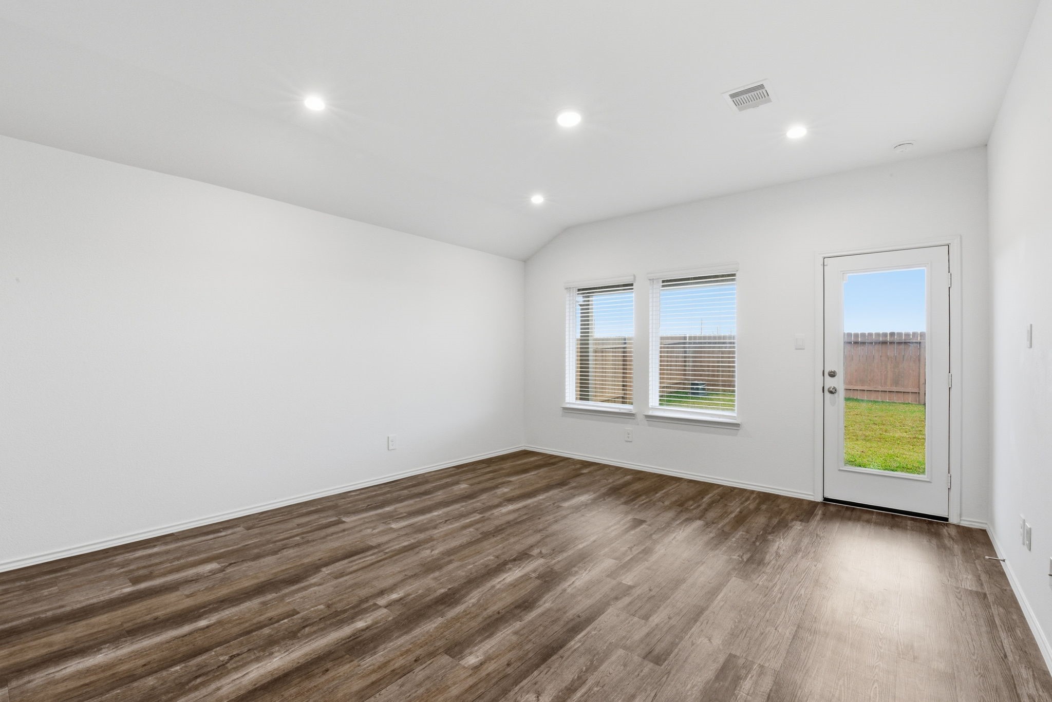 24343 Saddlestone Green Drive Spring, TX 77373 - Photo 11 of 43 an empty room with wooden floor and windows