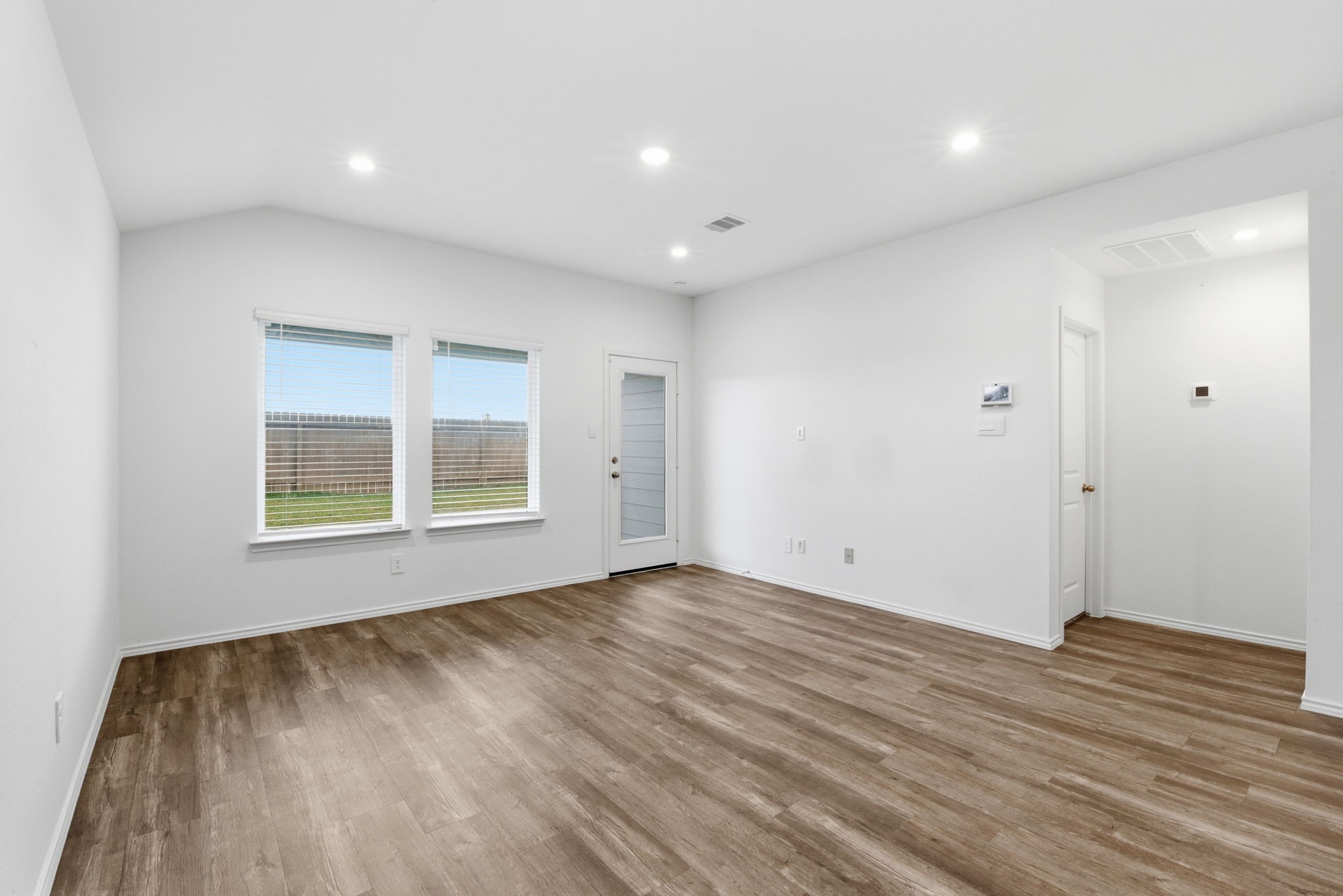 24343 Saddlestone Green Drive Spring, TX 77373 - Photo 13 of 43 a view of an empty room with wooden floor and a window