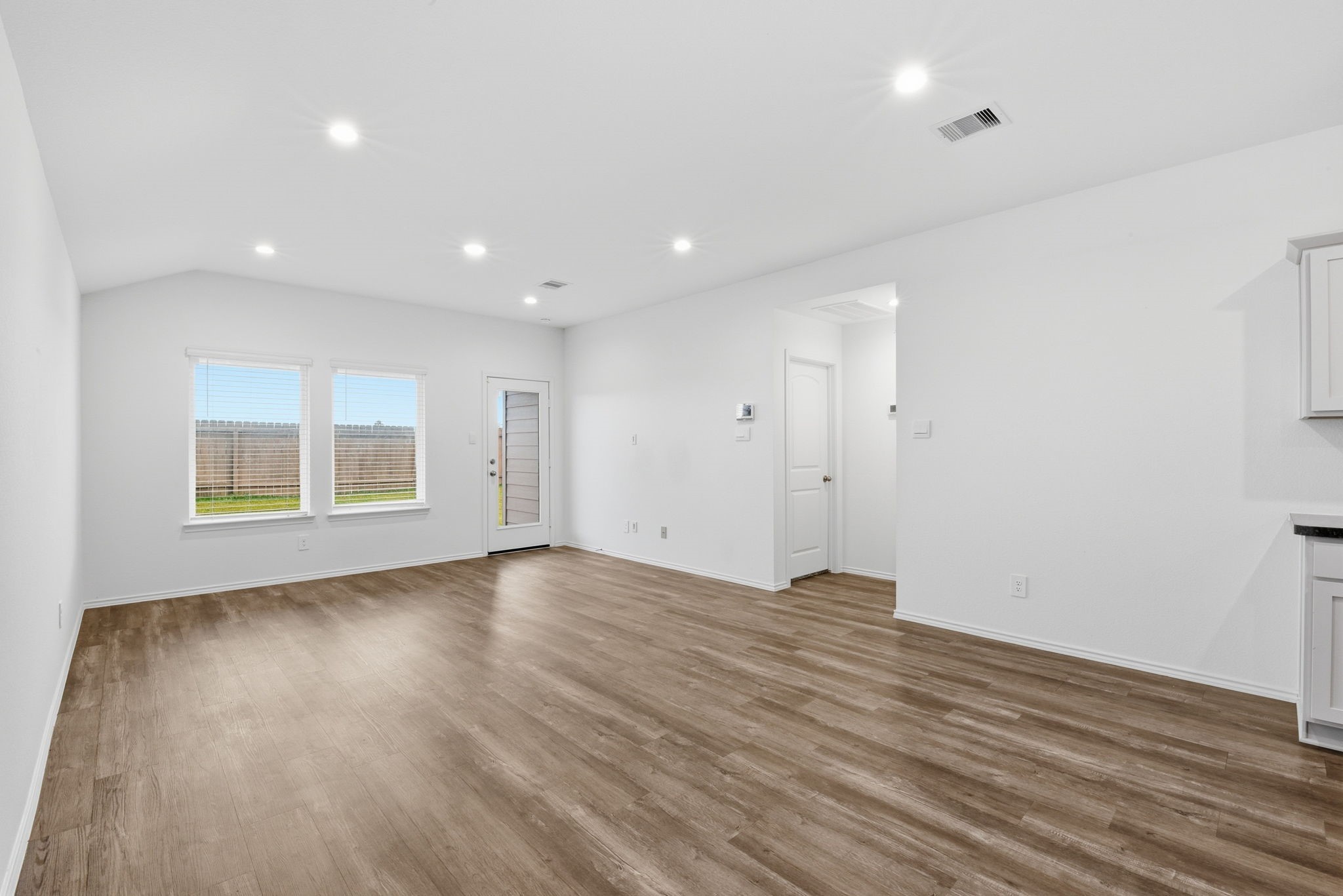 24343 Saddlestone Green Drive Spring, TX 77373 - Photo 18 of 43 a view of an empty room with wooden floor and a window
