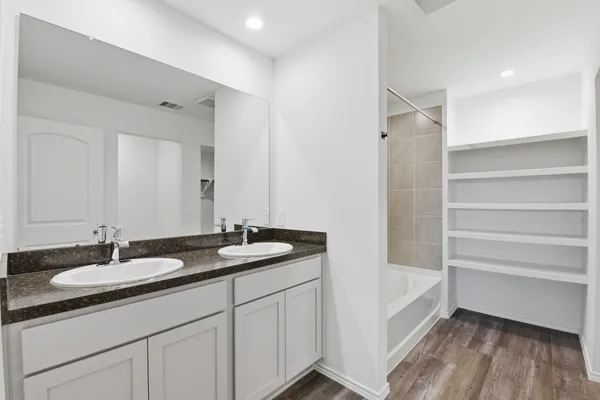 a bathroom with a sink double vanity and a mirror