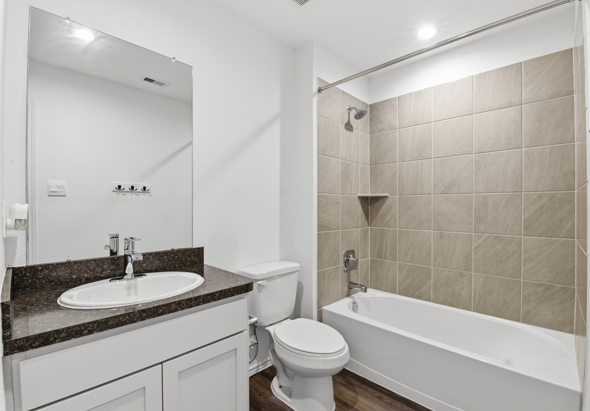 24343 Saddlestone Green Drive Spring, TX 77373 - Photo 38 of 43 a bathroom with a bath tub sink mirror vanity and toilet