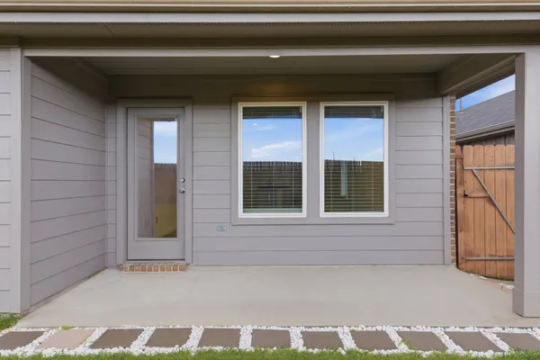 a view of a yard in front of a house with large tree