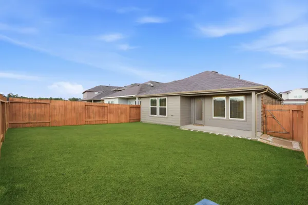 a view of a yard with a house in the background
