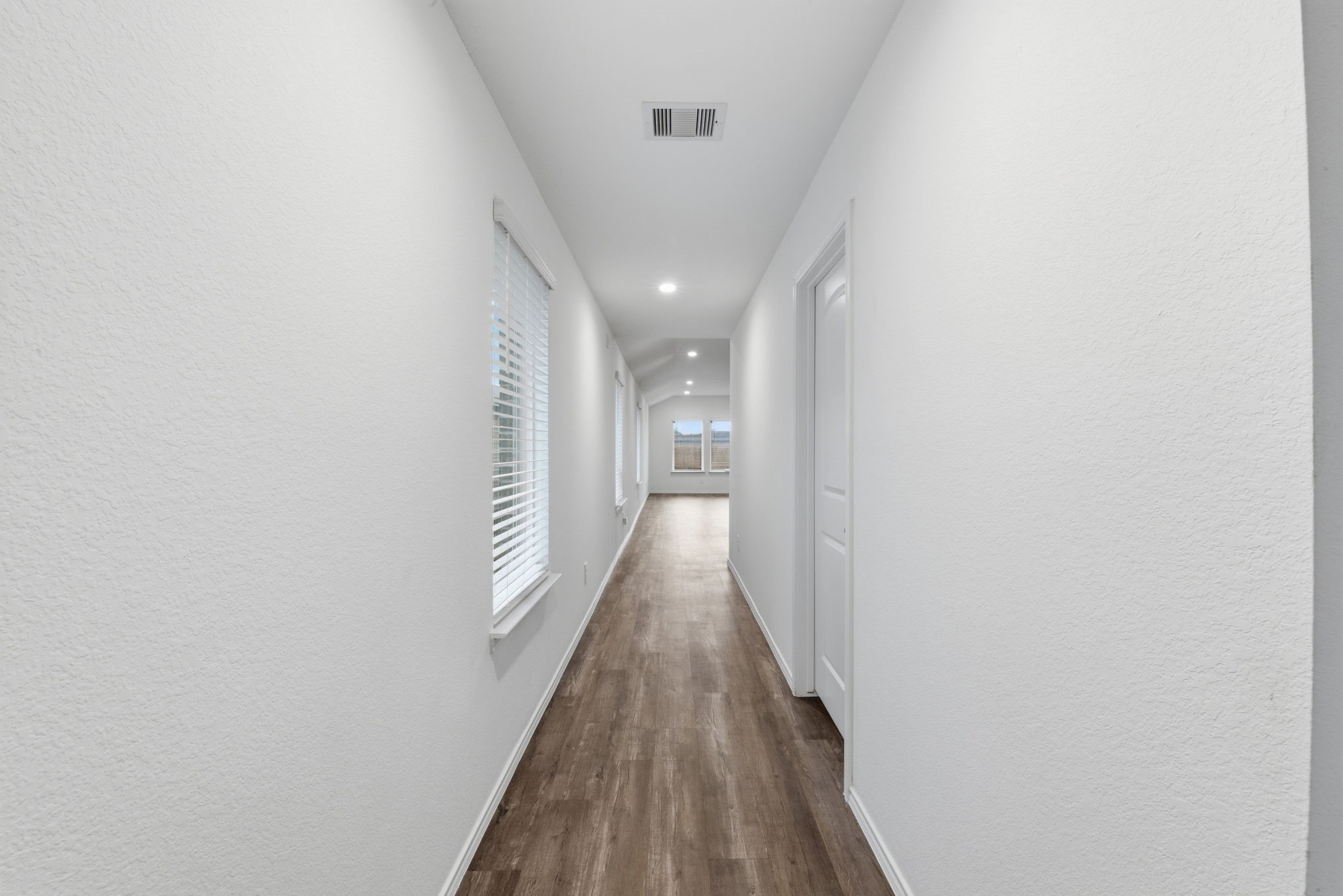 24343 Saddlestone Green Drive Spring, TX 77373 - Photo 7 of 43 a view of a hallway with wooden floor and staircase