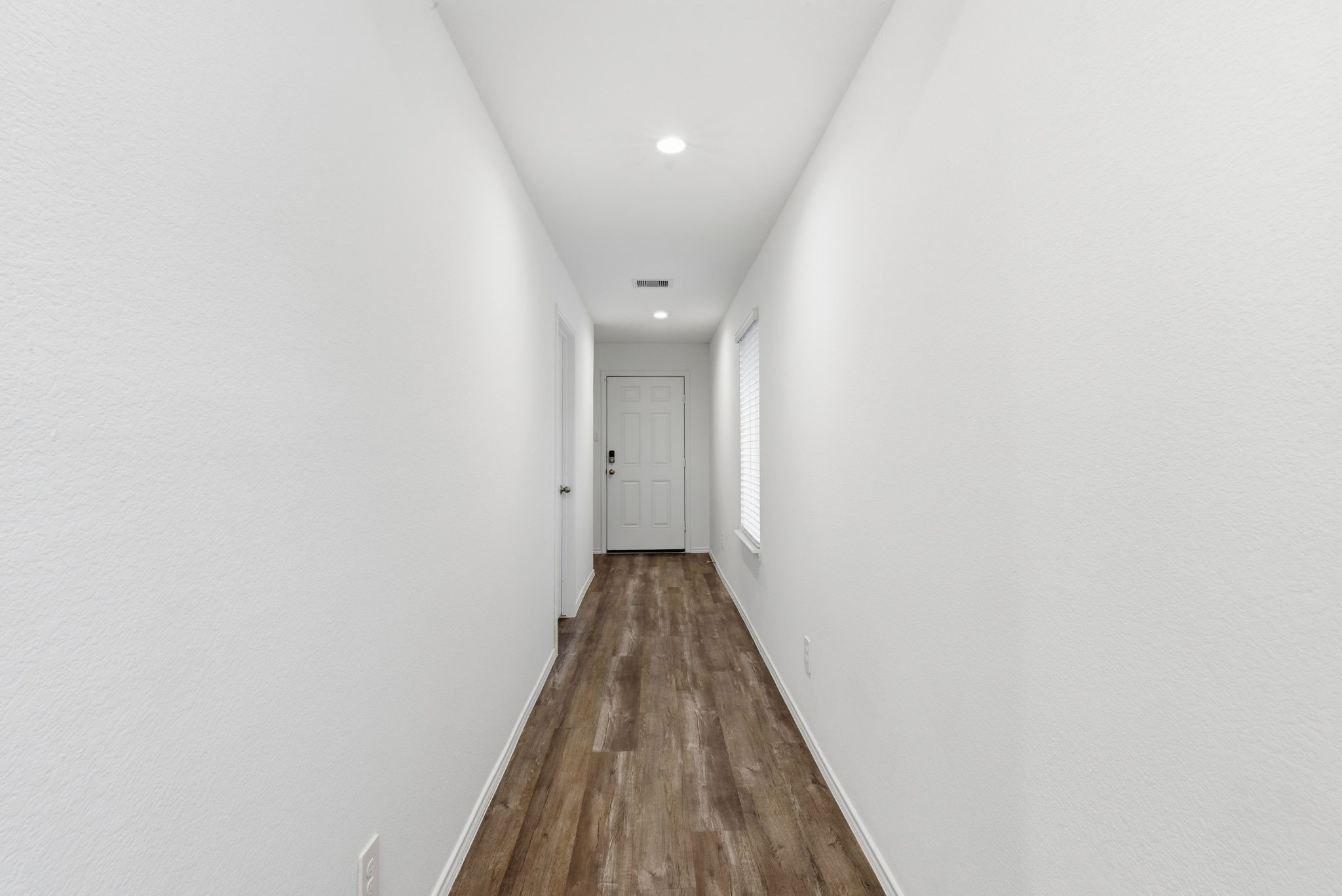24343 Saddlestone Green Drive Spring, TX 77373 - Photo 8 of 43 a view of a hallway with wooden floor