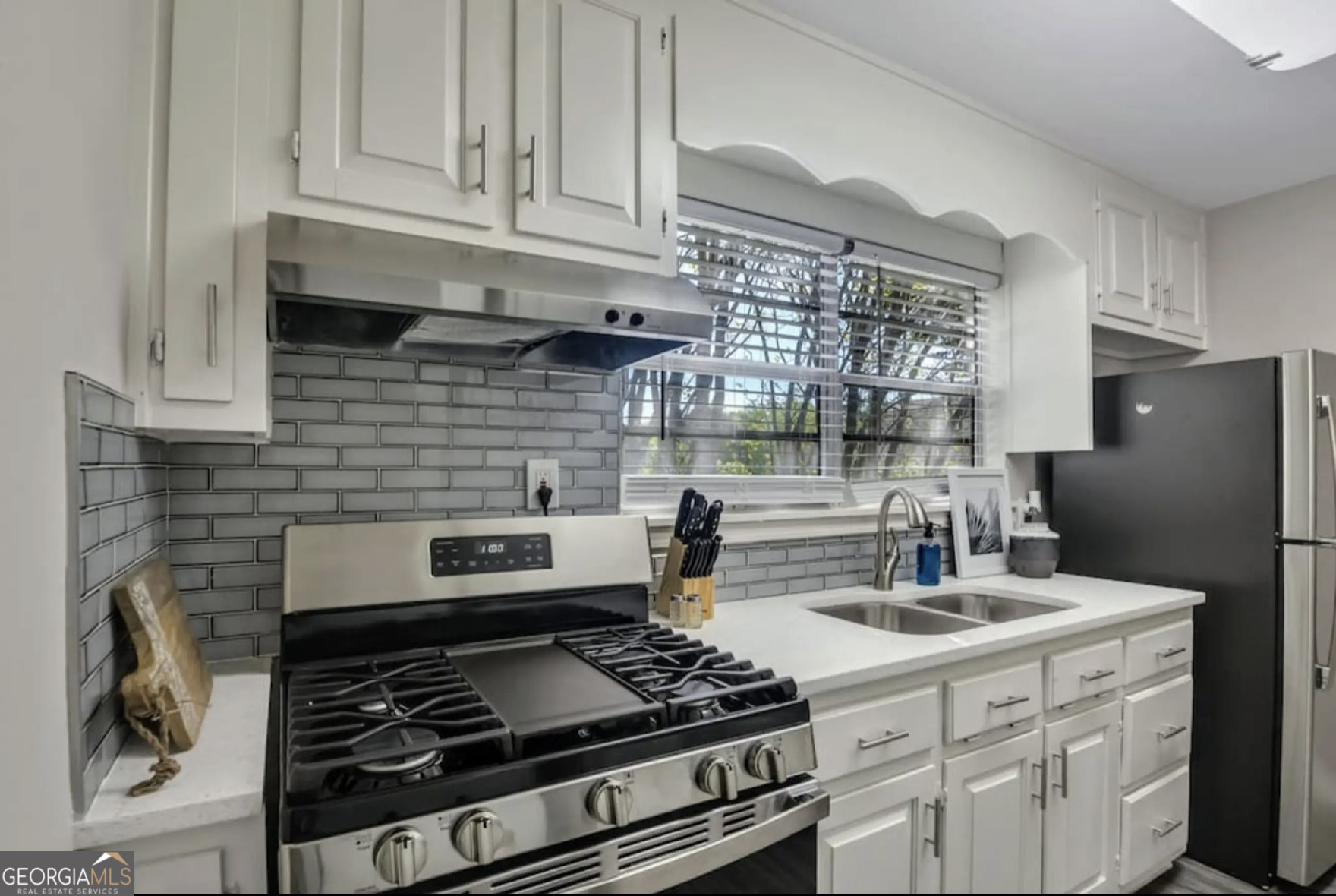 50 Oak Street Hiram, GA 30141 - Photo 4 of 16 a kitchen with a stove and white cabinets