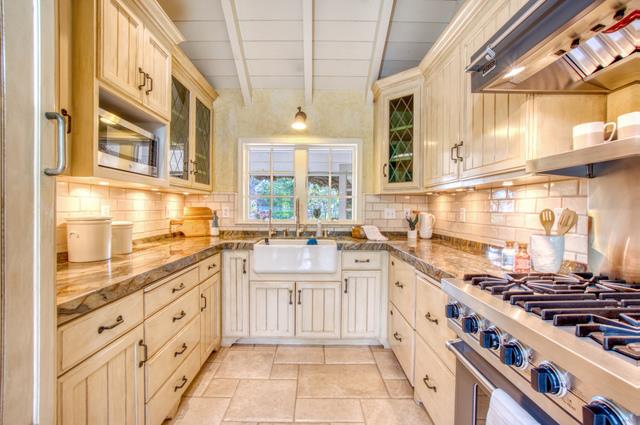 655 Bayview Drive Aptos, CA 95003 - Photo 13 of 48 a white kitchen with stainless steel appliances granite countertop a stove and a sink