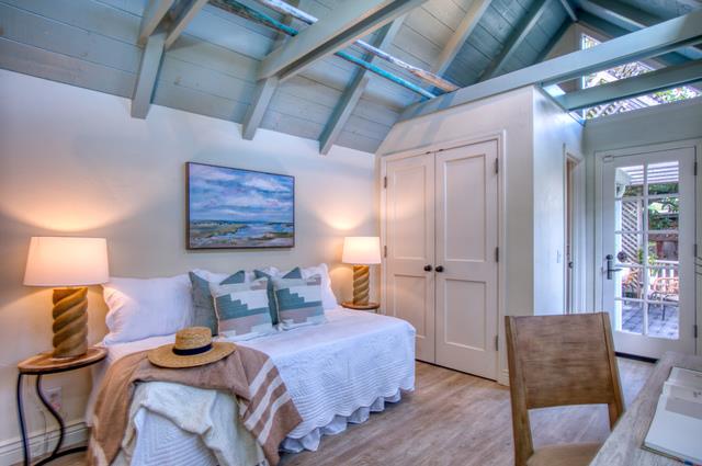 655 Bayview Drive Aptos, CA 95003 - Photo 18 of 48 a bedroom with furniture and a chandelier