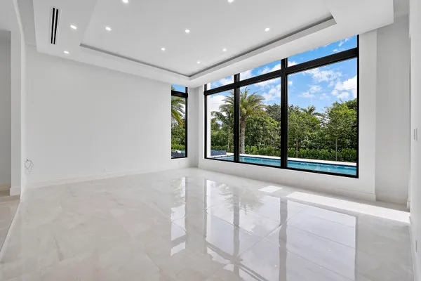 a large kitchen with a large counter top stainless steel appliances and cabinets