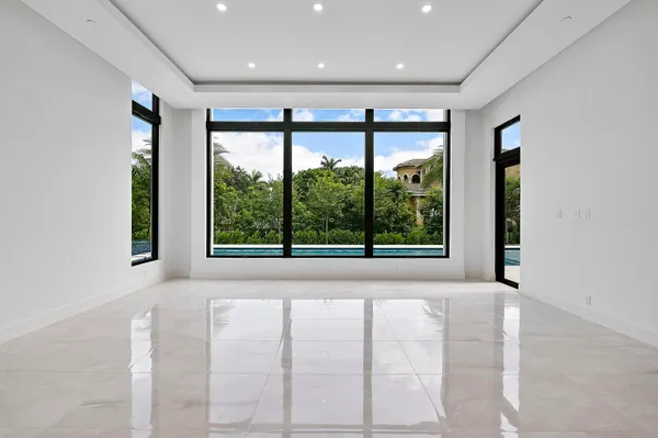 a view of a hallway with stainless steel appliances
