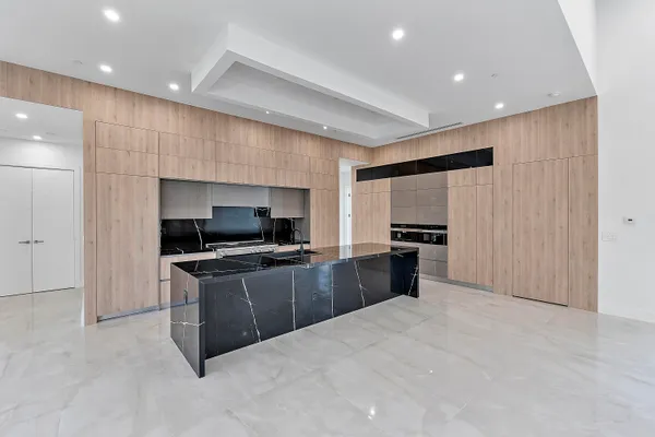 a kitchen with white cabinets and a sink
