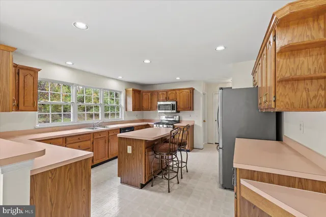 a kitchen with a sink a counter top space and stainless steel appliances