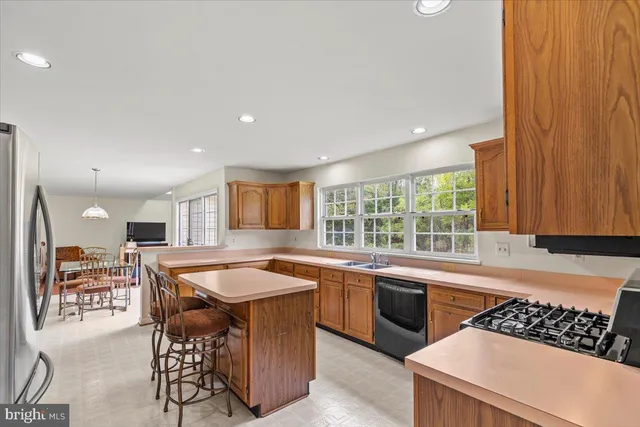 a bedroom with a bed dresser and a large window