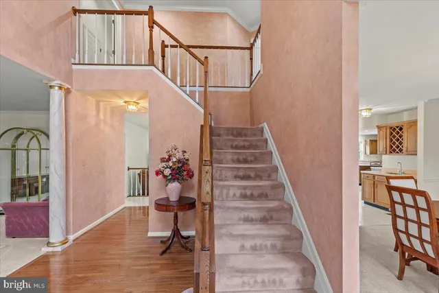 a view of entryway and hall with wooden floor