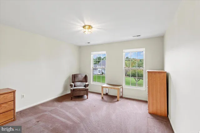a living room with chairs and a table