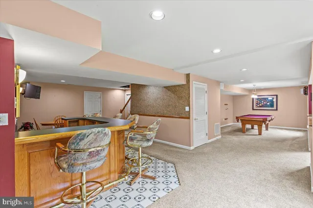 a room with pool table and a chandelier