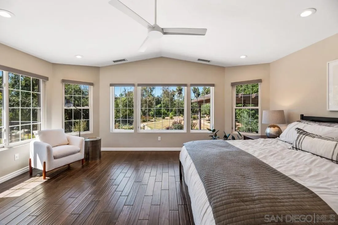 a spacious bedroom with a large bed and a large window
