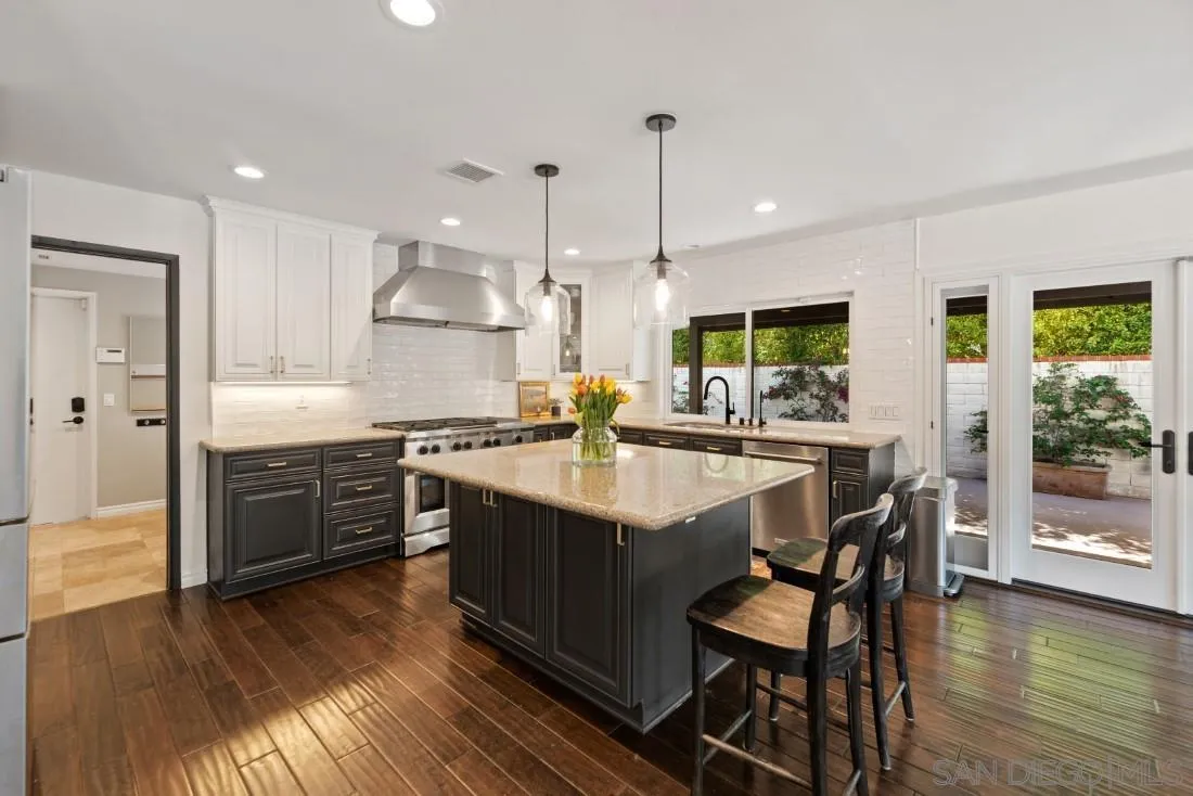 13060 Camino Del Valle Poway, CA 92064 - Photo 18 of 75 a kitchen with stainless steel appliances granite countertop wooden floor a stove a sink and a refrigerator