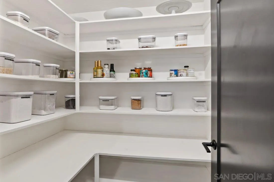 13060 Camino Del Valle Poway, CA 92064 - Photo 19 of 75 a view of kitchen cabinets with food items with white countertops