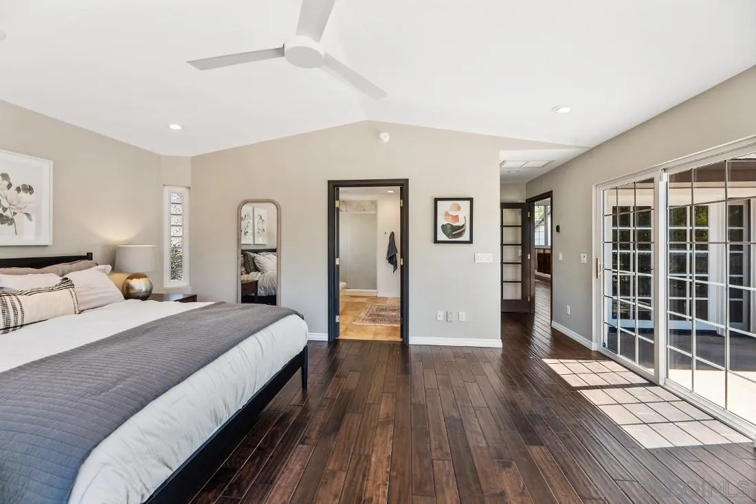 13060 Camino Del Valle Poway, CA 92064 - Photo 29 of 75 a spacious bedroom with a large bed and a wooden floor