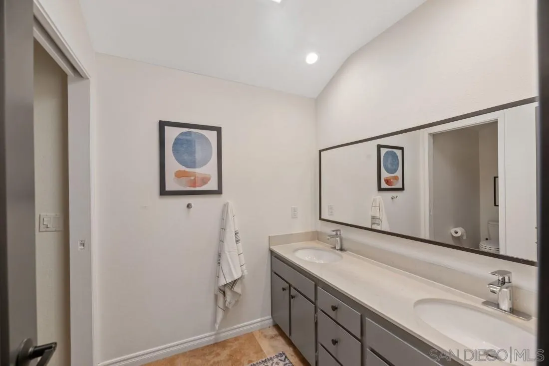 13060 Camino Del Valle Poway, CA 92064 - Photo 42 of 75 a bathroom with a granite countertop sink mirror and vanity