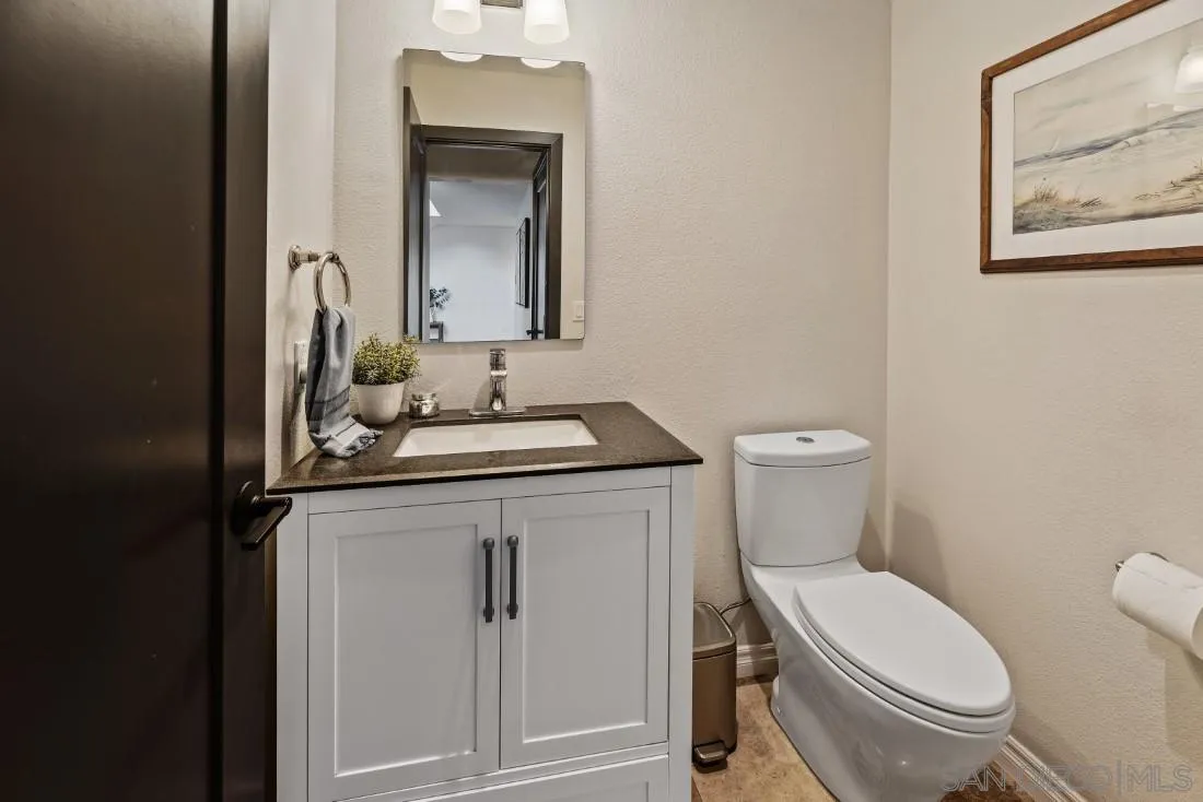 13060 Camino Del Valle Poway, CA 92064 - Photo 6 of 75 a bathroom with a toilet a sink and mirror
