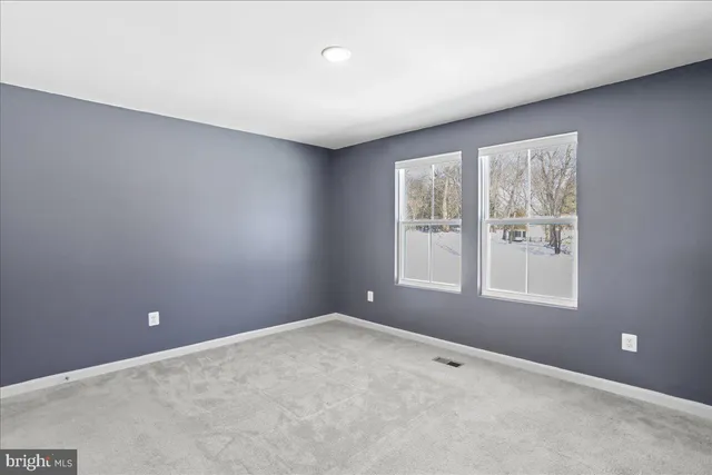 an empty room with closet and a bathroom