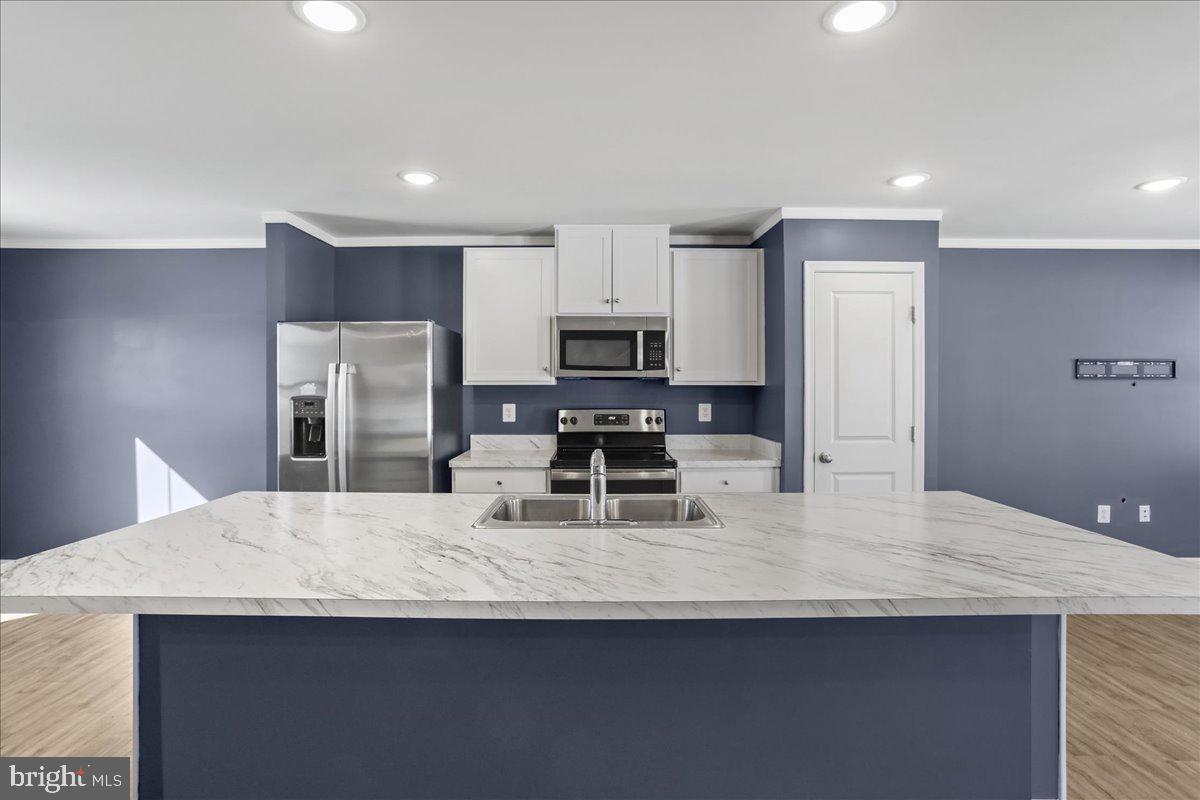 46 Scoter Road Hedgesville, WV 25427 - Photo 5 of 28 a kitchen with refrigerator and chairs