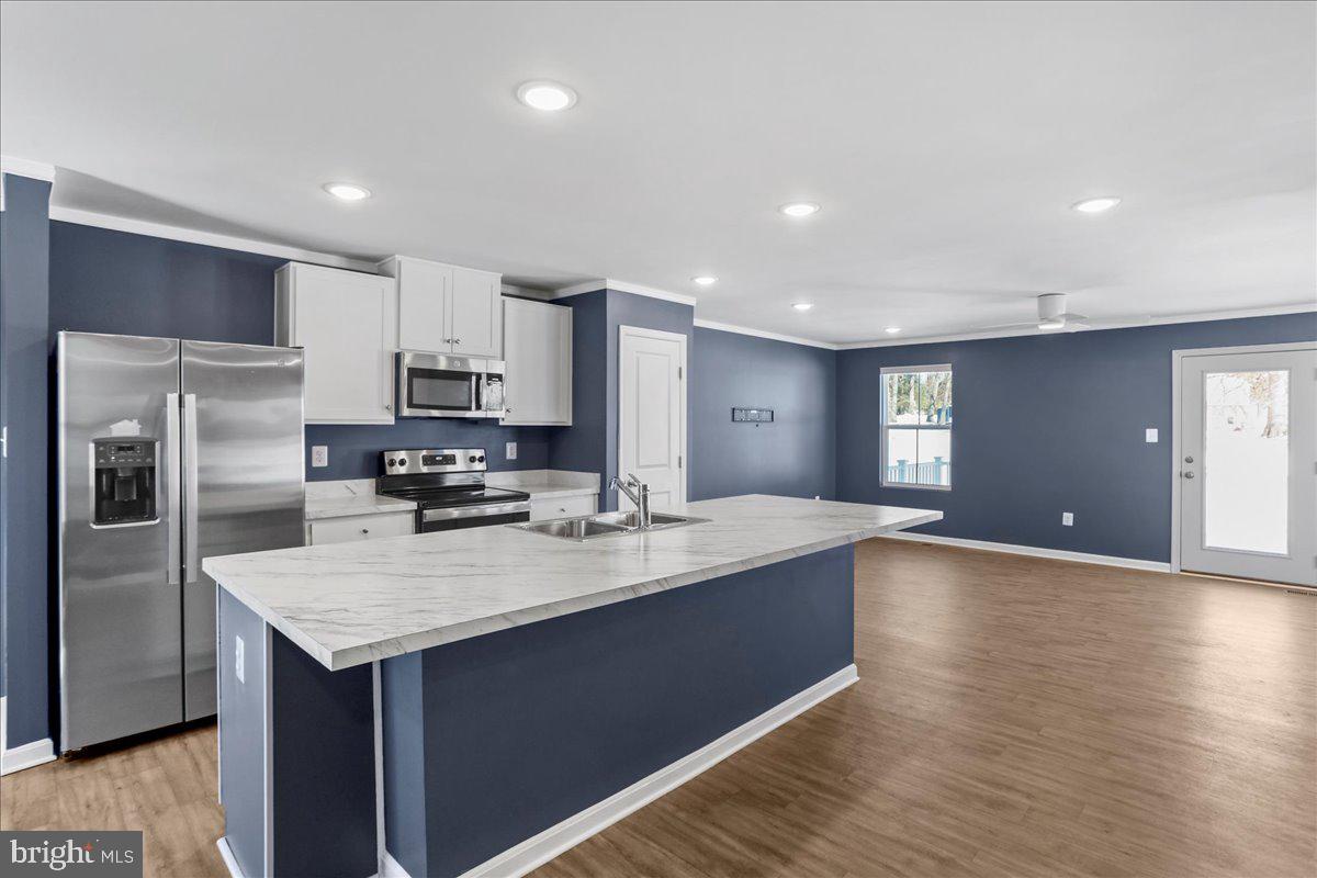 46 Scoter Road Hedgesville, WV 25427 - Photo 7 of 28 a kitchen with kitchen island a sink appliances and cabinets