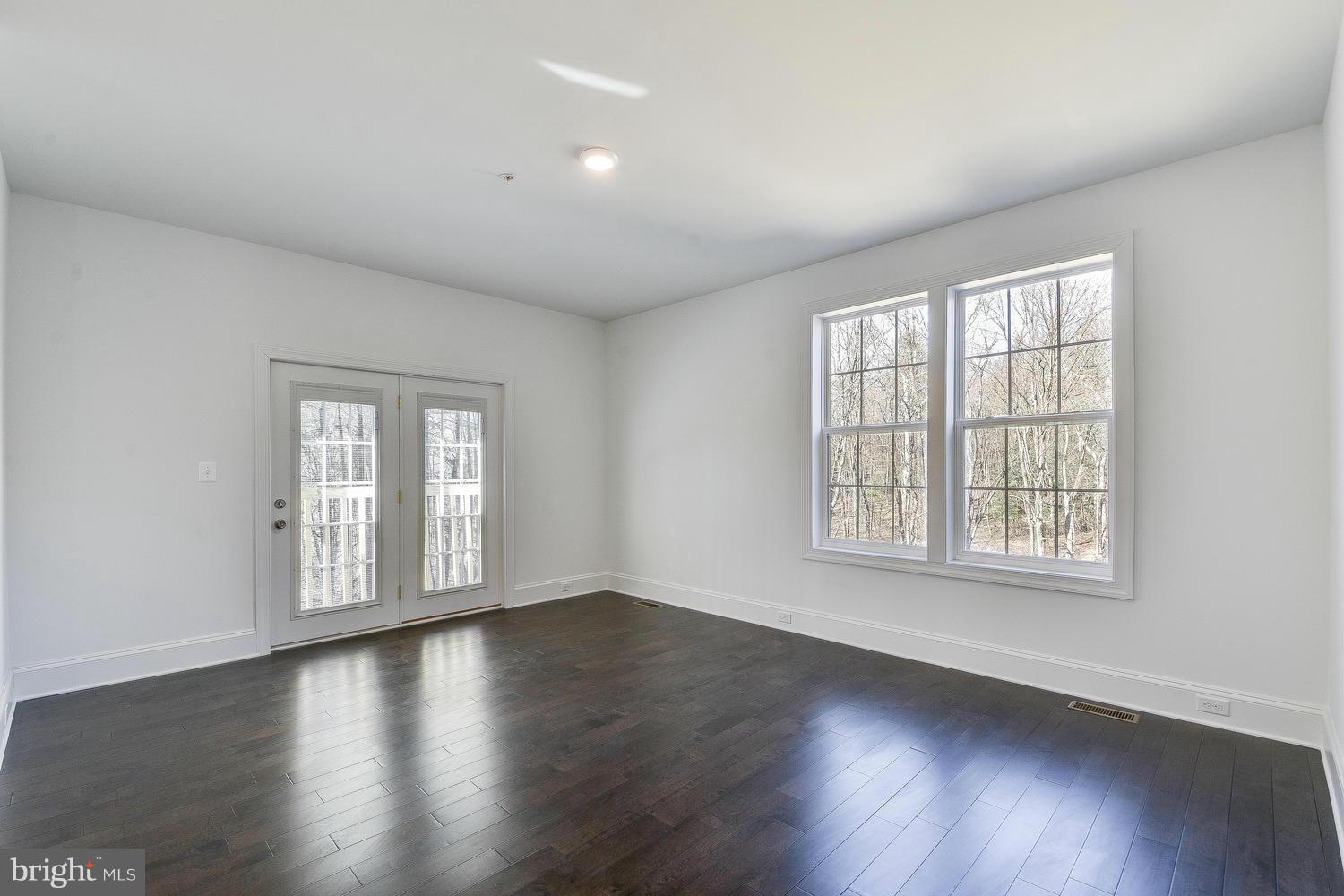 3526 Kemptown Church Road Monrovia, MD 21770 - Photo 14 of 29 an empty room with wooden floor and windows with curtains view
