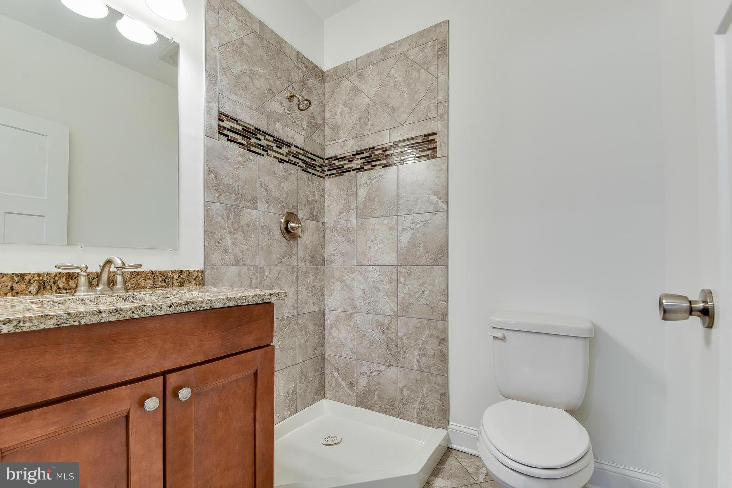 3526 Kemptown Church Road Monrovia, MD 21770 - Photo 22 of 29 a bathroom with a granite countertop sink mirror toilet and shower