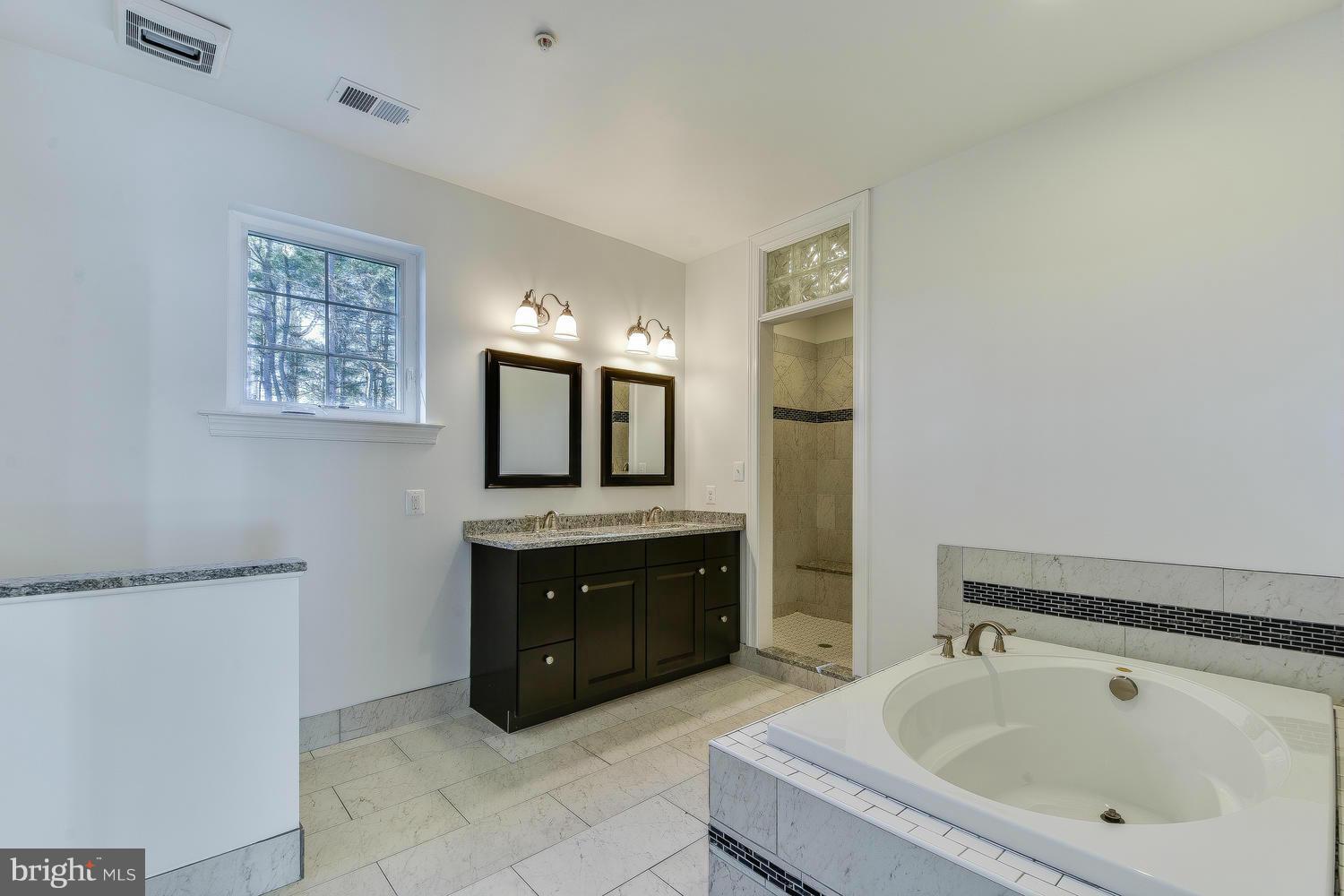3526 Kemptown Church Road Monrovia, MD 21770 - Photo 27 of 29 a spacious bathroom with a tub sink and mirror