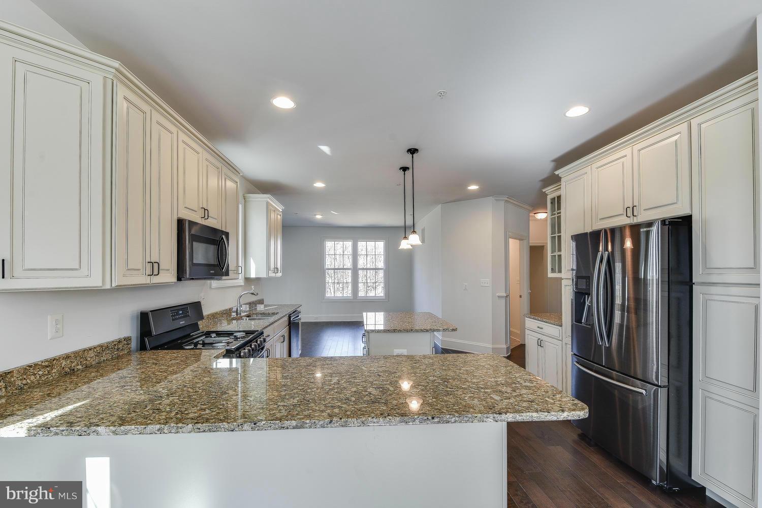 3526 Kemptown Church Road Monrovia, MD 21770 - Photo 10 of 29 a kitchen with stainless steel appliances granite countertop a refrigerator a stove a sink a dining table and chairs