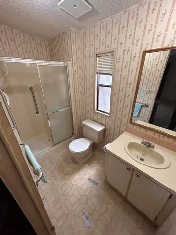 a view of an empty room with large windows