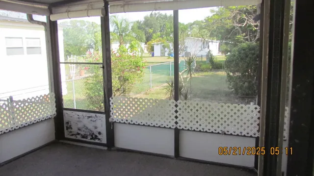 a view of an empty room with large windows