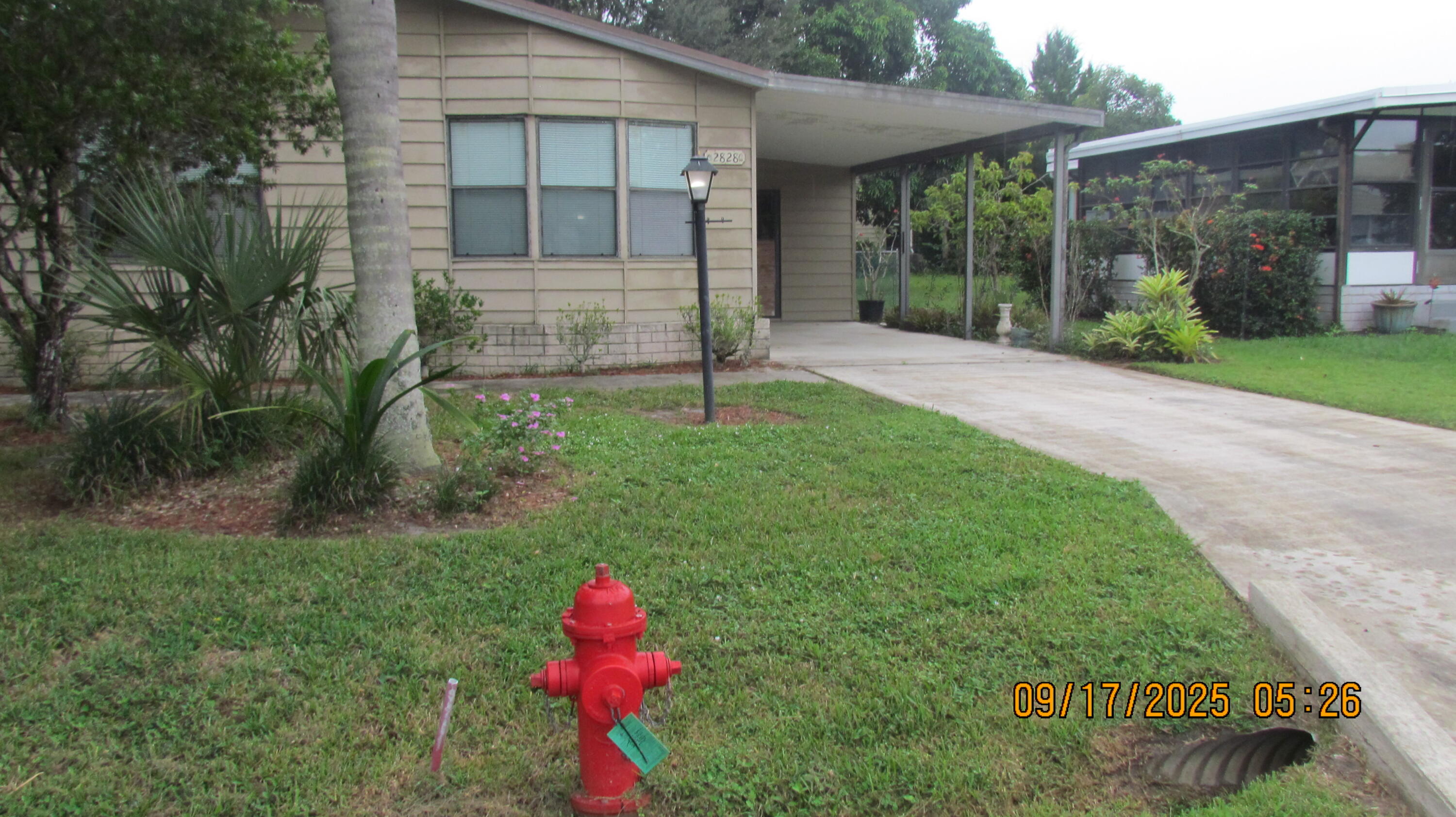 2828 Southwest Toronado Trail Stuart, FL 34997 - Photo 2 of 23 a view of a house with a yard