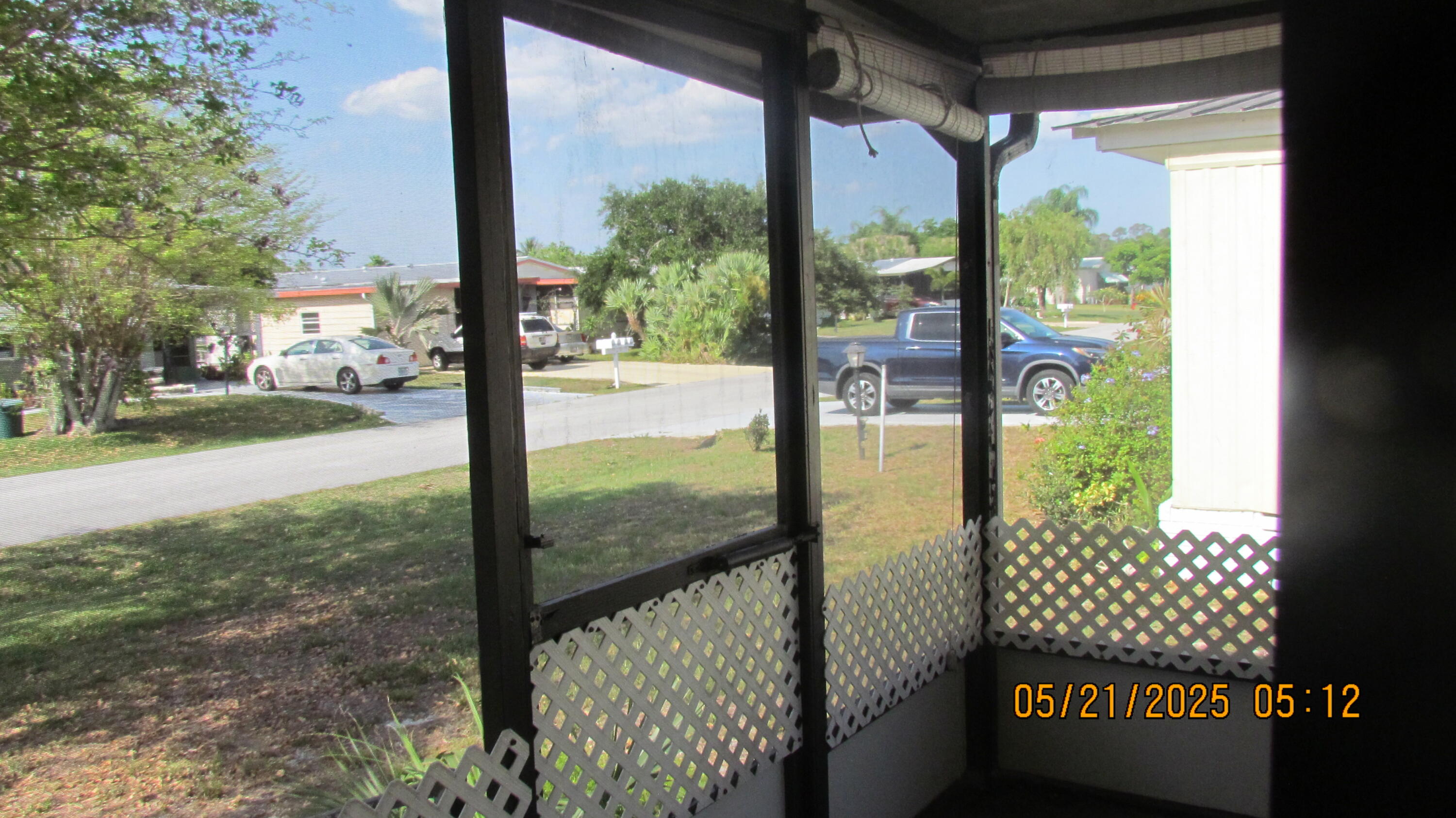 2828 Southwest Toronado Trail Stuart, FL 34997 - Photo 21 of 23 a view of a porch with a floor to ceiling window next to a yard