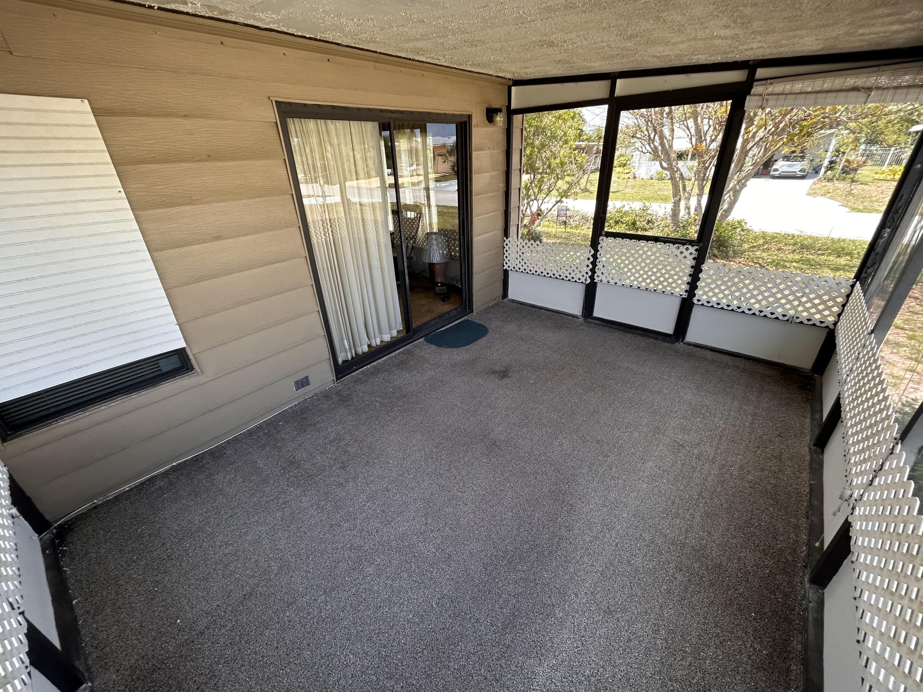 2828 Southwest Toronado Trail Stuart, FL 34997 - Photo 22 of 23 a view of an empty room with large windows