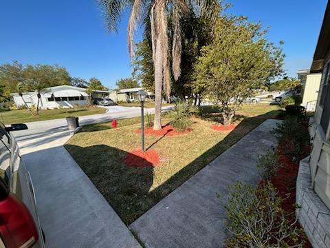 2828 Southwest Toronado Trail Stuart, FL 34997 - Photo 4 of 23 a view of a yard with an outdoor seating