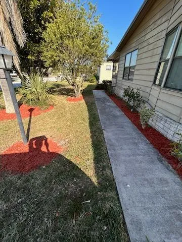 a view of a house with a backyard