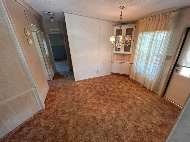 a kitchen with a refrigerator a stove top oven and a sink