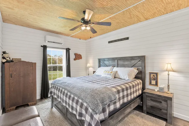 a bedroom with a bed and a chandelier