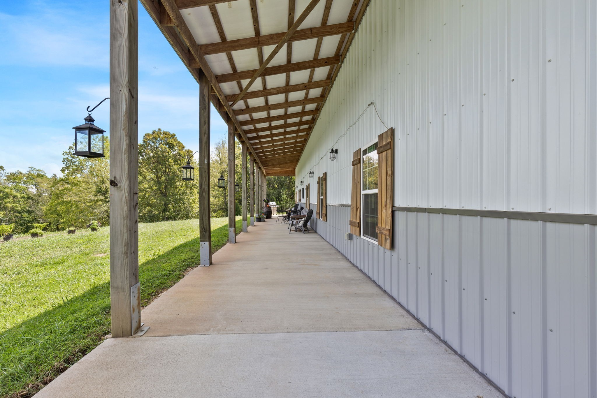 1818 Preacher Holt Road Mount Pleasant, TN 38474 - Photo 8 of 38 a view of a porch with a floor to ceiling window and a yard