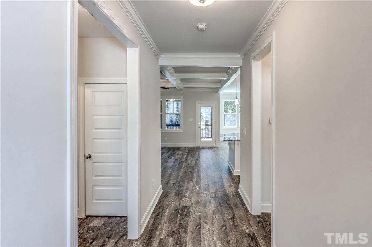 2305 Pilot-Riley Road Zebulon, NC 27597 - Photo 4 of 20 a view of a hallway with wooden floor and staircase