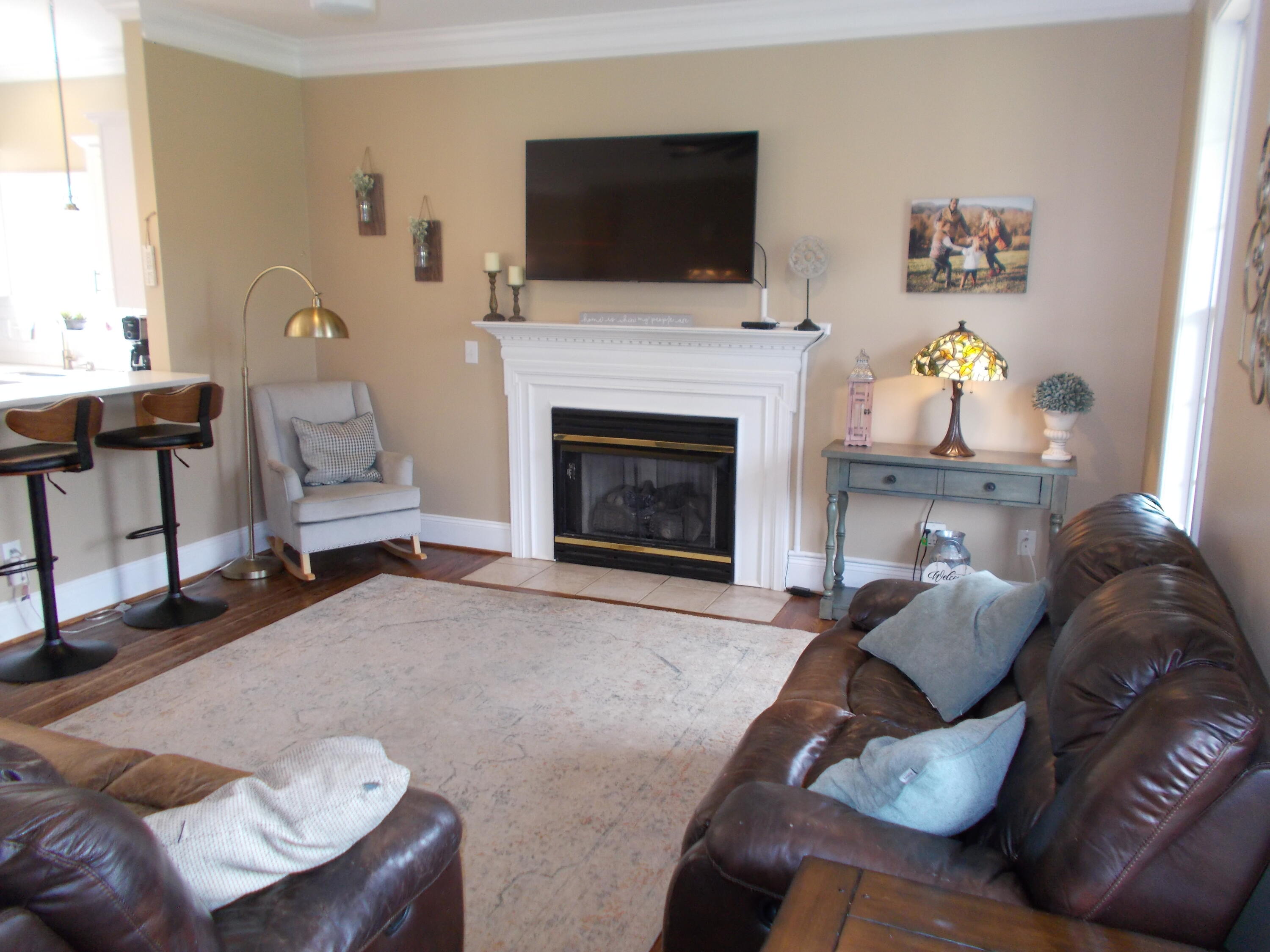 4420 Bethlehem Road Boones Mill, VA 24065 - Photo 5 of 43 a living room with furniture a flat screen tv and a fireplace