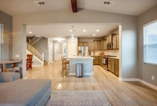 a living room with kitchen island furniture and a kitchen view